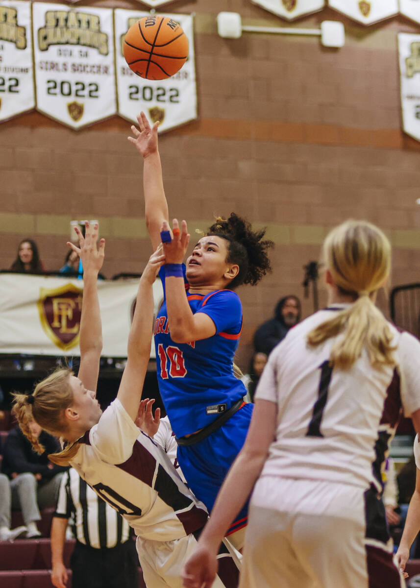 Bishop Gorman point guard Aaliah Spaight (10) tries to make a rebound during a game at Faith Lu ...