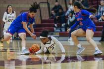 Faith Lutheran’s Tamiah Harrison (4) reaches to grab the ball after falling between Bish ...
