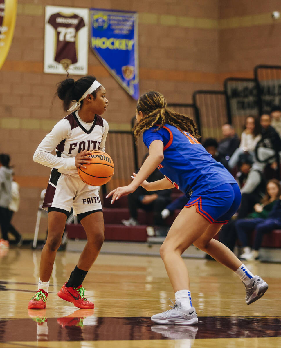 Faith Lutheran’s Tamiah Harrison (4) looks to move the ball to a teammate during a game ...