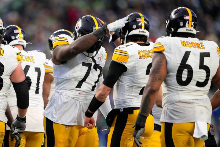 Pittsburgh Steelers offensive tackle Broderick Jones greets quarterback Mason Rudolph (2) durin ...
