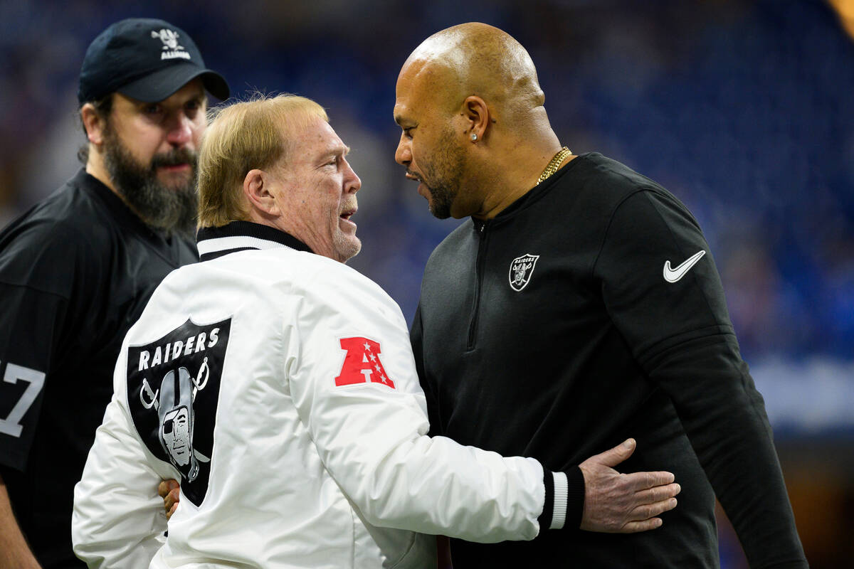 Las Vegas Raiders interim head coach Antonio Pierce and Las Vegas Raiders owner Mark Davis hug ...