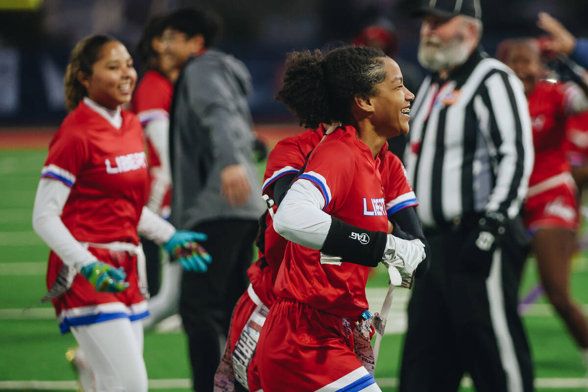 Liberty flag football players celebrate a play during a game against Shadow Ridge at Liberty Hi ...