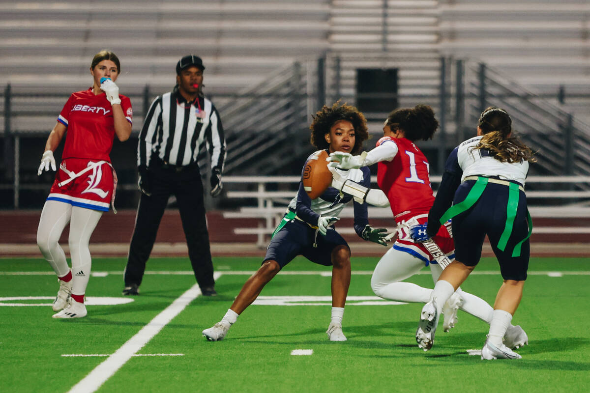 Liberty wide receiver Porsha Pitts carries the ball down the field during a game at Liberty Hig ...