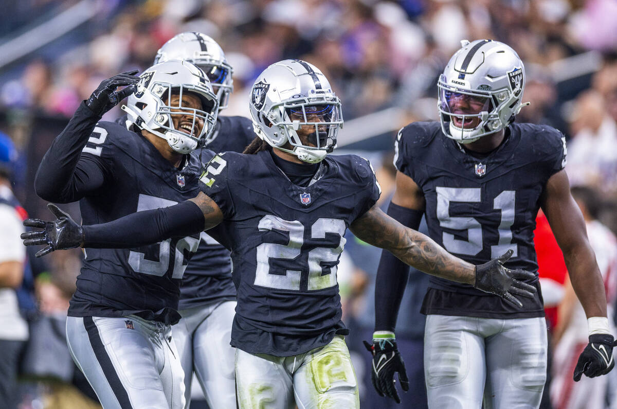 Vegas Raiders running back Ameer Abdullah (22) and teammates celebrate a big tackle on a punt d ...