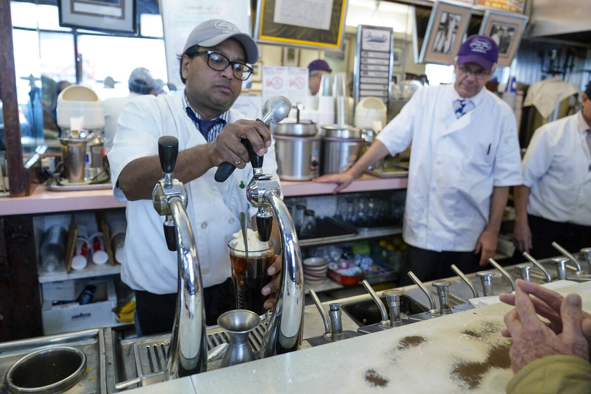 File - An employee of the Lexington Candy Shop prepares a Coke float at the luncheonette on Sep ...