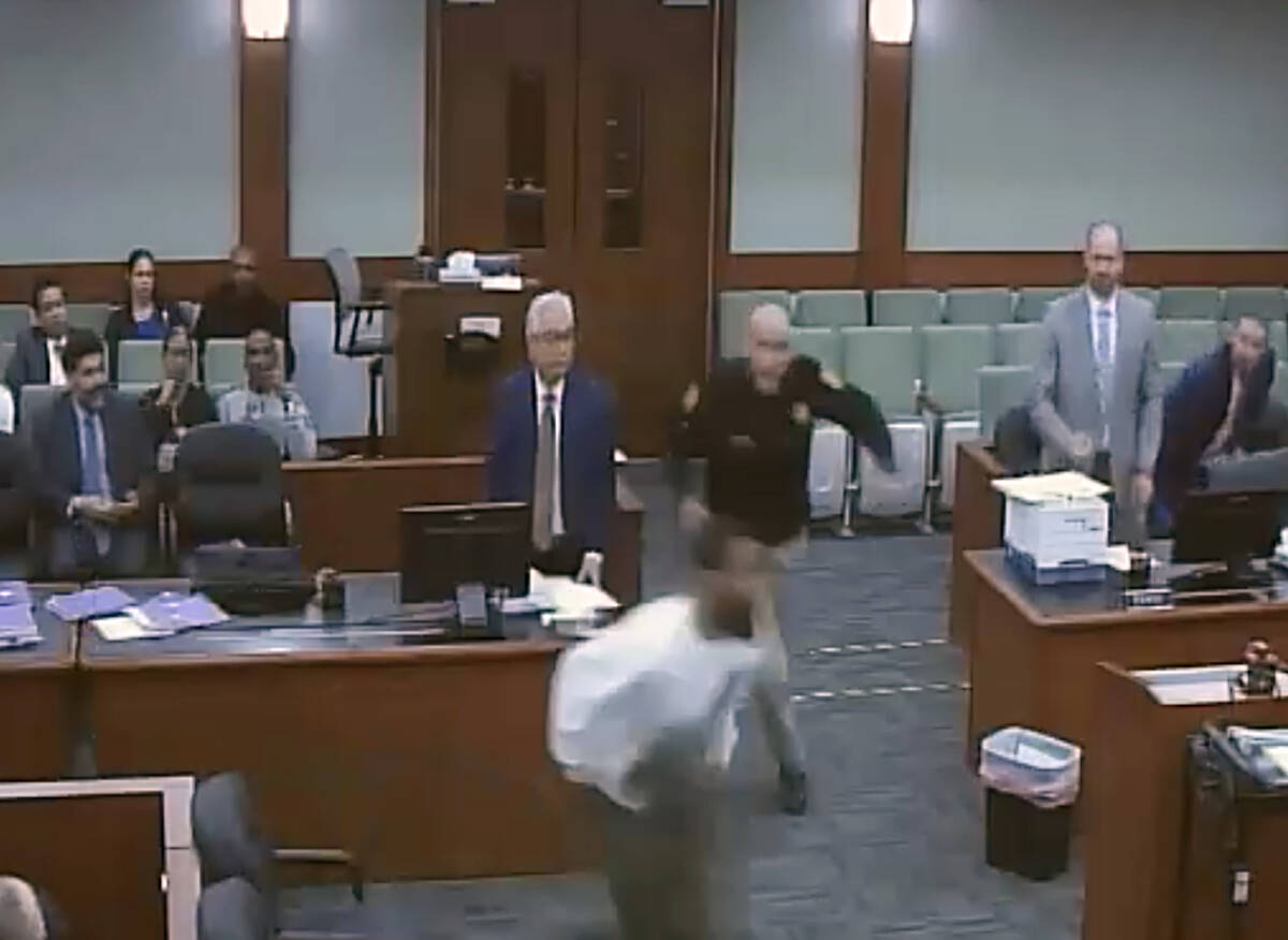This is a video screen shot of defendant Deobra Redden rushing to attack Judge Mary Kay Holthus ...