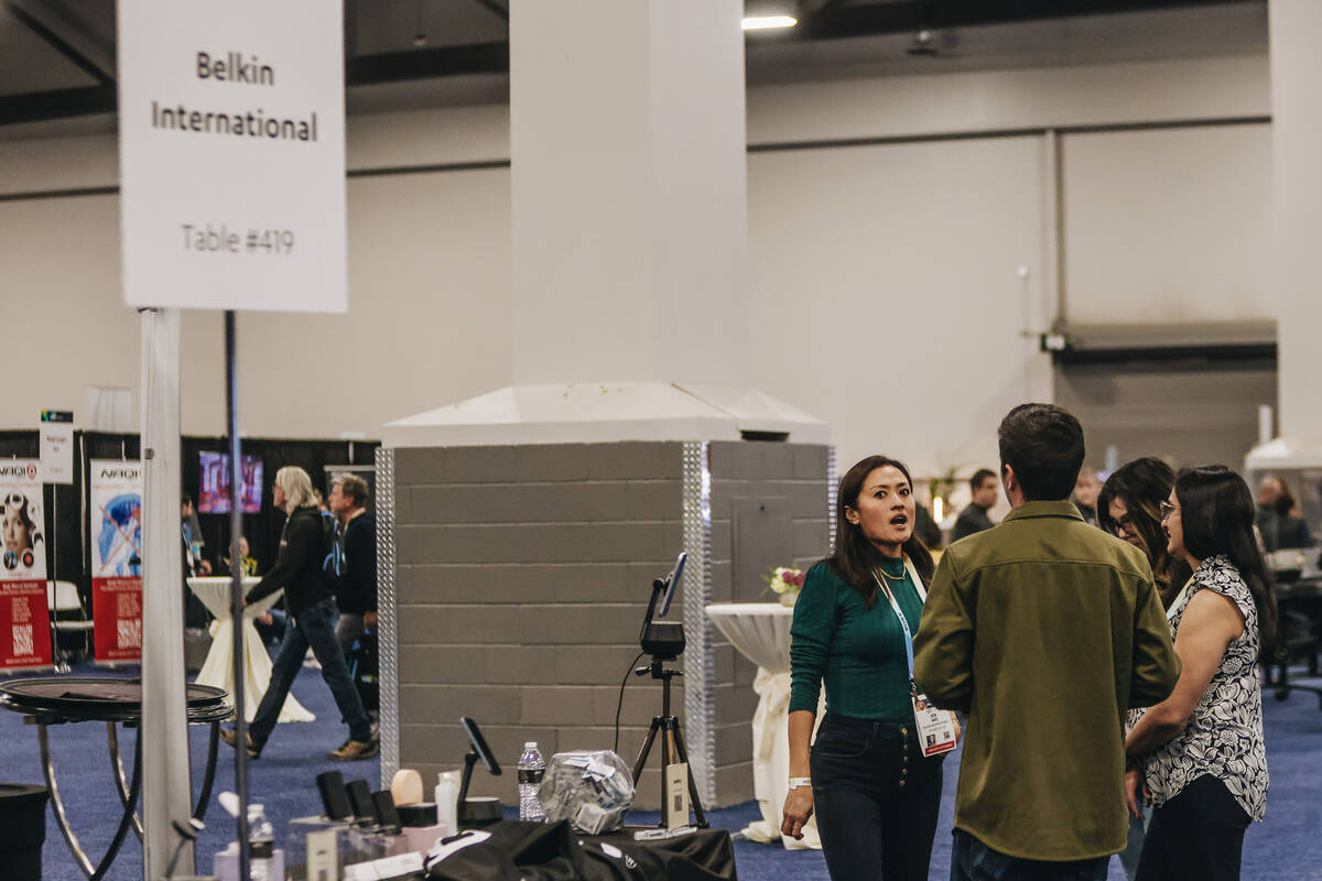 People speak to each other during CES Unveiled at the Mandalay Bay Convention Center on Sunday, ...