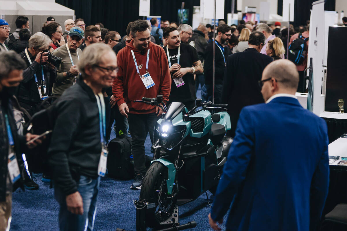 People rake a look at a motorcycle by Verge Motorcycles during CES Unveiled at the Mandalay Bay ...