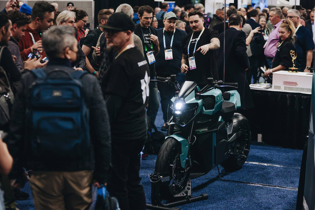 People rake a look at a motorcycle by Verge Motorcycles during CES Unveiled at the Mandalay Bay ...