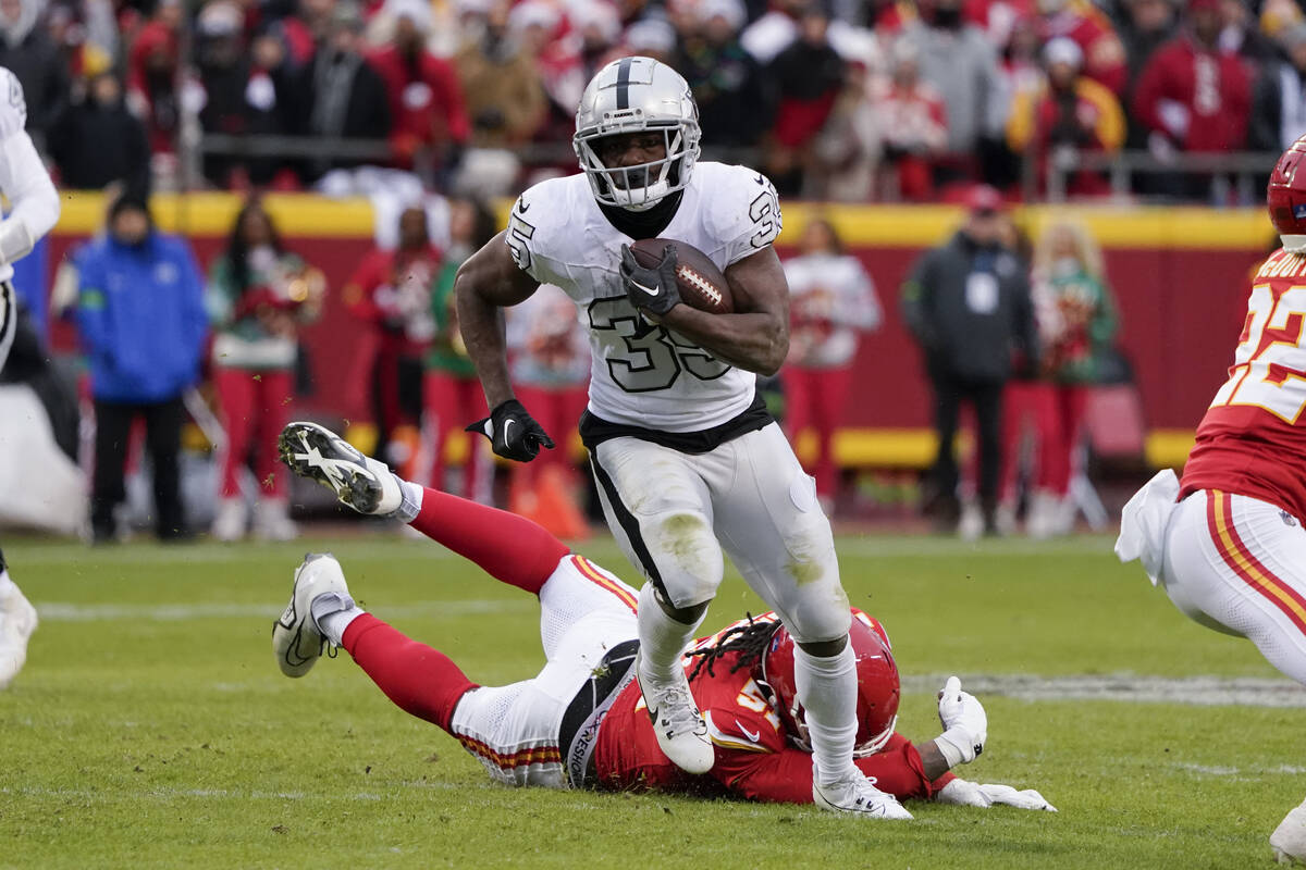 Las Vegas Raiders running back Zamir White (35) runs against Kansas City Chiefs defensive end M ...