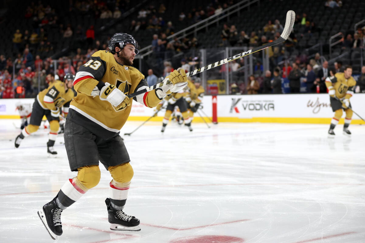 Golden Knights center Paul Cotter (43) raises his stick after shooting during warmups before an ...