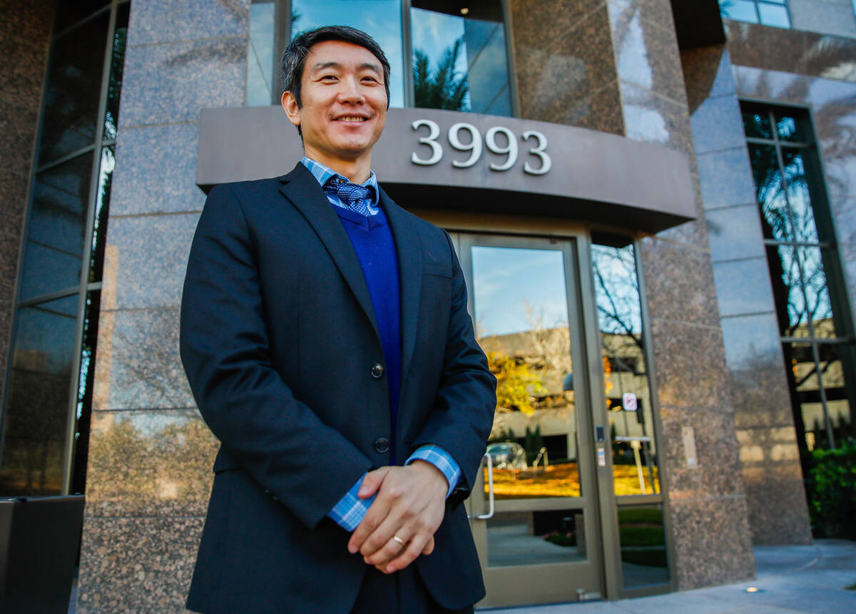 Meng Zhong, Pro Bono Attorney of the Year as honored by the Legal Aid Center, stands in front o ...