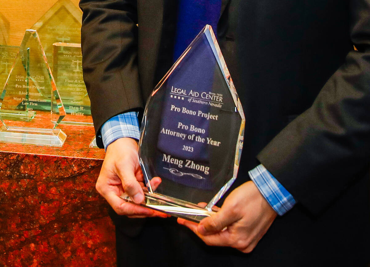 Meng Zhong, Pro Bono Attorney of the Year as selected by the Legal Aid Center, holds his honora ...