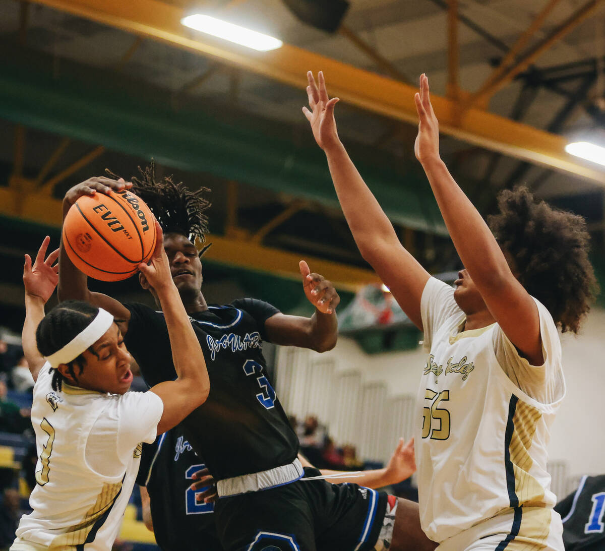 Desert Pines forward Damonte Duhart (3) fights for the ball to get a rebound during a game at S ...