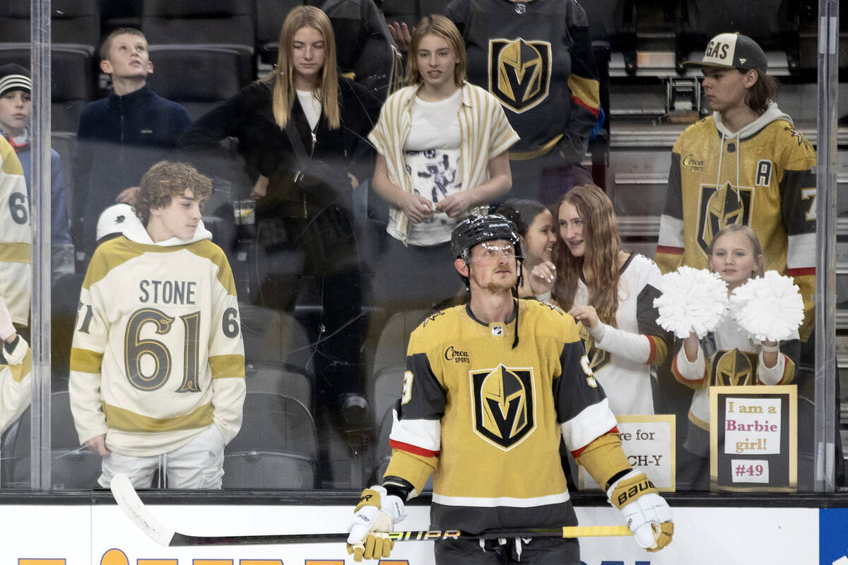 Golden Knights center Jack Eichel (9) warms up while fans giggle behind him before an NHL hocke ...
