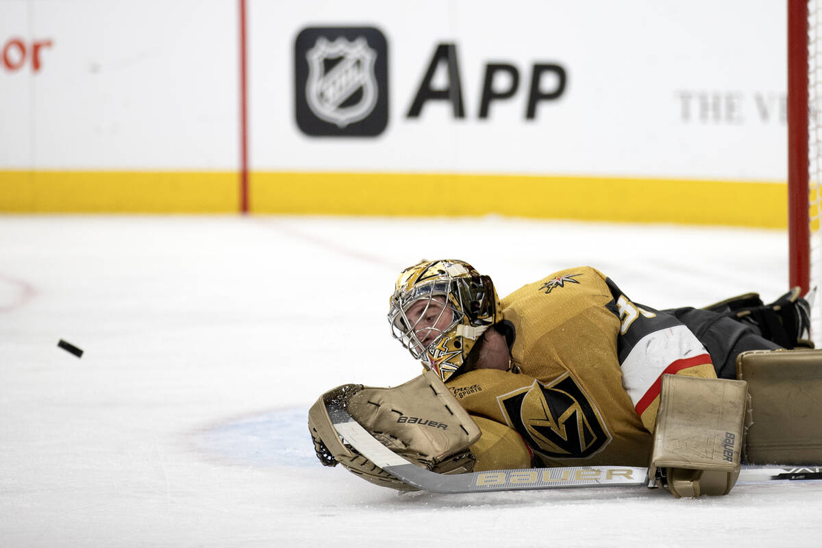Golden Knights goaltender Logan Thompson (36) dives to save the puck during the second period o ...