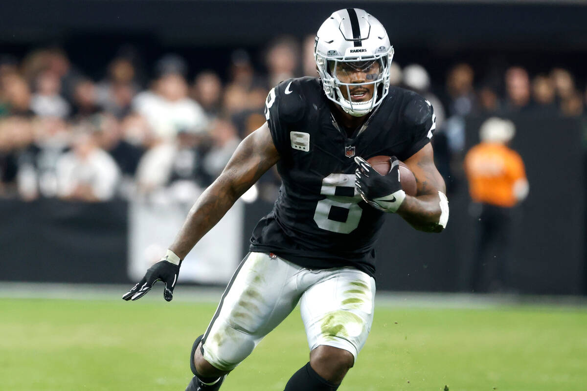 Raiders running back Josh Jacobs (8) runs with the ball during the second half of an NFL footb ...