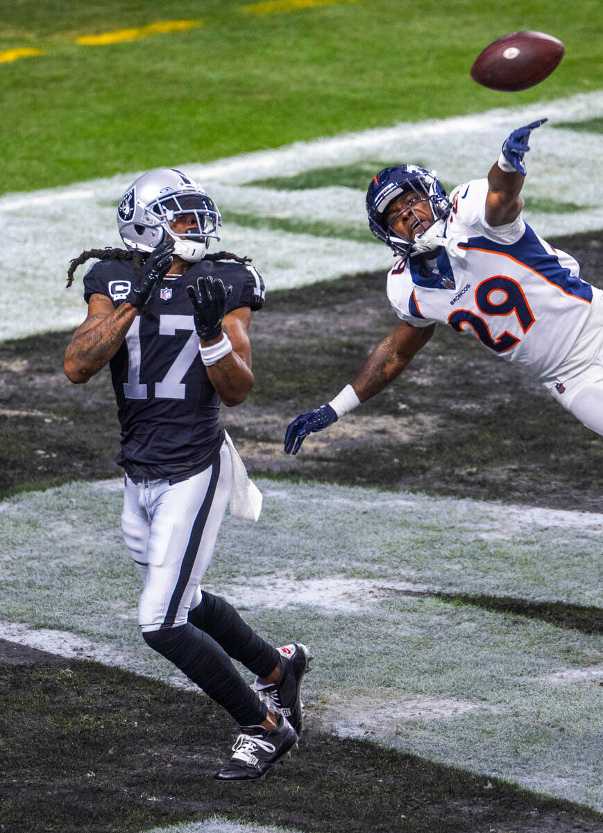 Raiders wide receiver Davante Adams (17) eyes a touchdown pass as Denver Broncos cornerback Ja' ...
