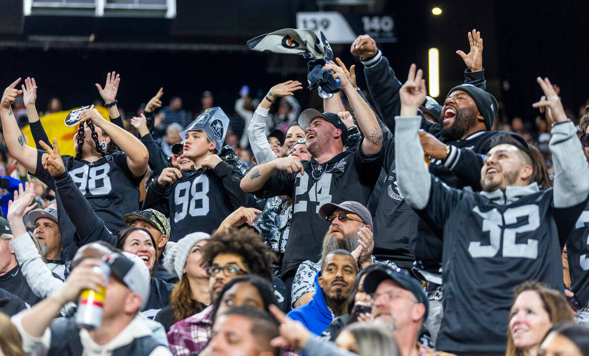 Raiders fans celebrate another score over the Denver Broncos during the second half of their NF ...