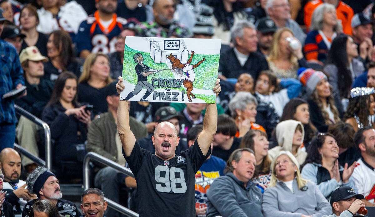 A raiders fan is big on defensive end Maxx Crosby (98) against the Denver Broncos during the se ...