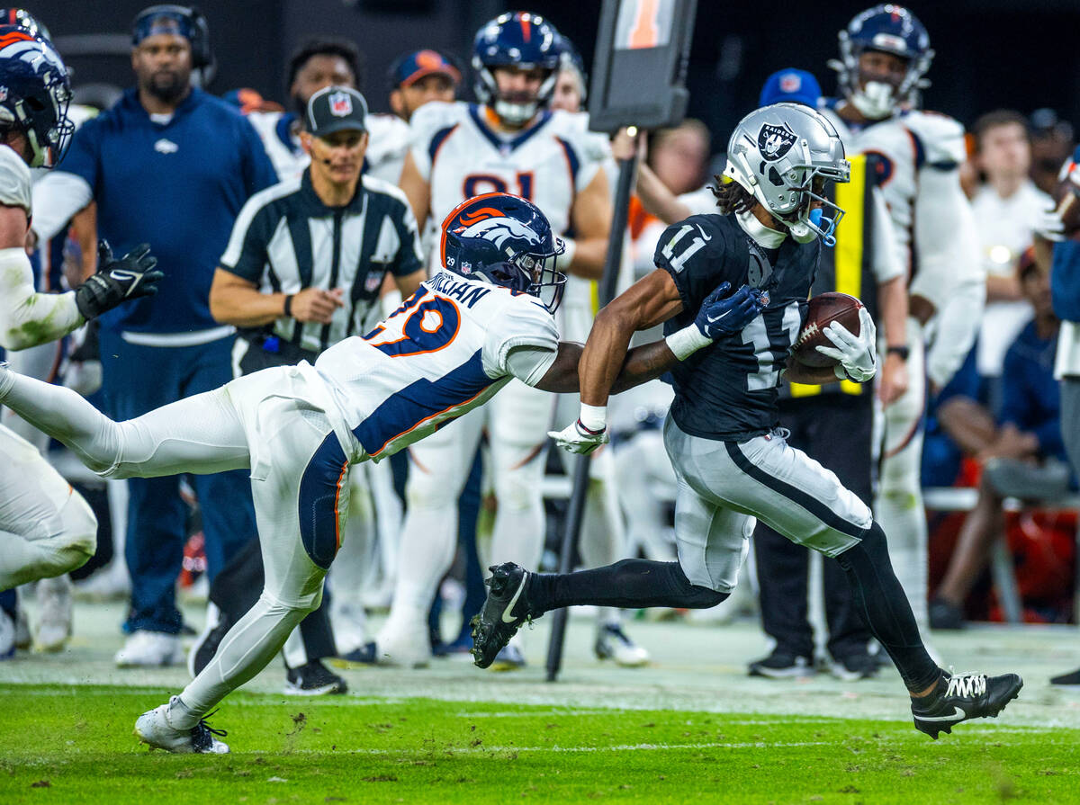 Raiders wide receiver Tre Tucker (11) sprints away from Denver Broncos cornerback Ja'Quan McMil ...