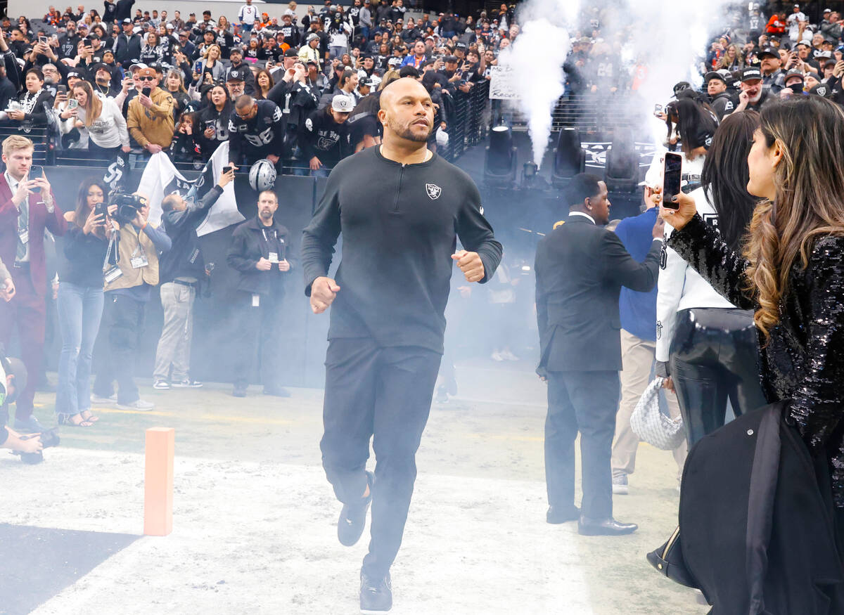 Raiders Interim Coach Antonio Pierce takes the field to face the Denver Broncos during an NFL f ...