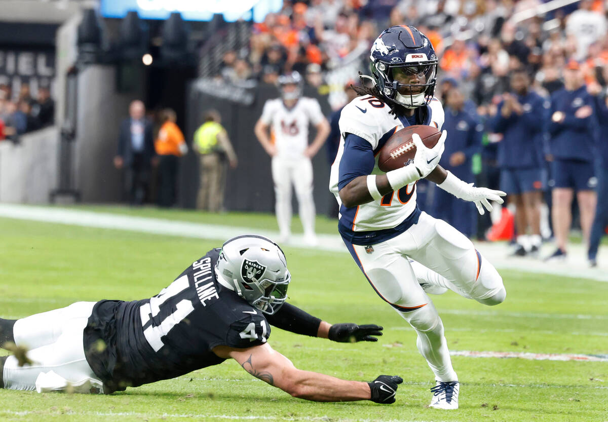 Denver Broncos wide receiver Jerry Jeudy (10) avoids a tackle from Raiders linebacker Robert Sp ...