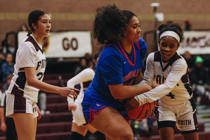 Faith Lutheran’s Tamiah Harrison (4) and Bishop Gorman forward ALiitasi Fakatoumafi (34) ...