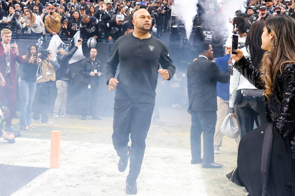 Raiders Interim Coach Antonio Pierce takes the field to face the Denver Broncos during an NFL f ...