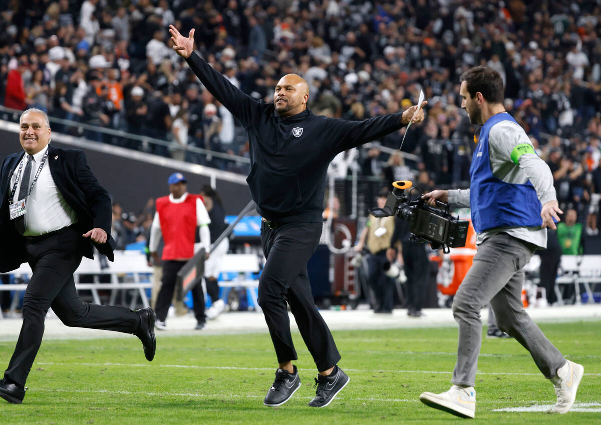 Raiders Interim Coach Antonio Pierce reacts as he leaves the field after beating the Denver Bro ...
