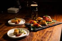 A variety of pintxos, right, are pictured alongside Croquetas de Jamon, above, and Iberico Kats ...