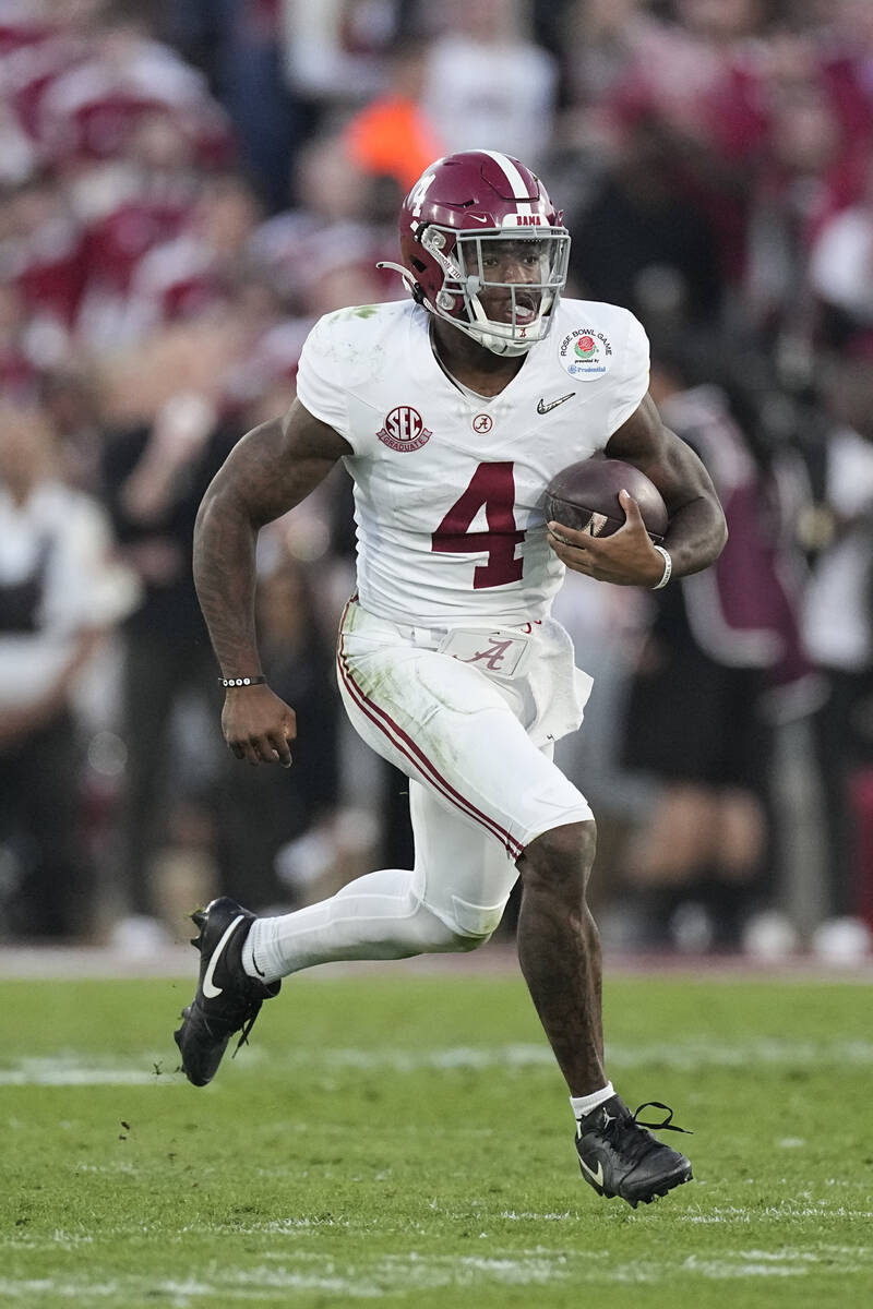Alabama quarterback Jalen Milroe (4) carries against Michigan during the second half in the Ros ...