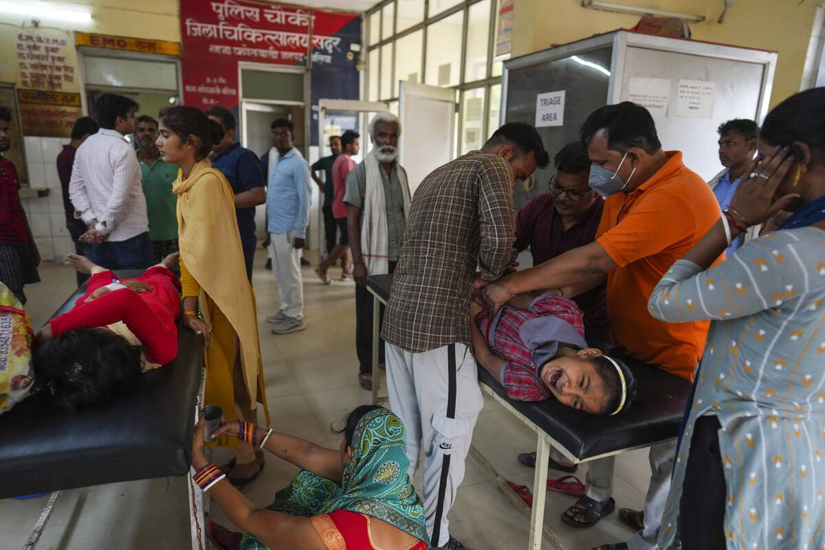 People suffering from heat related ailments crowd the district hospital in Ballia, Uttar Prades ...