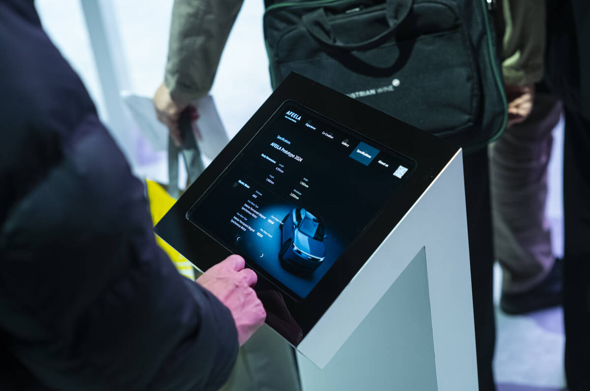 An attendee reads about the AFEELA Prototype from Sony Honda Mobility during the first day of C ...