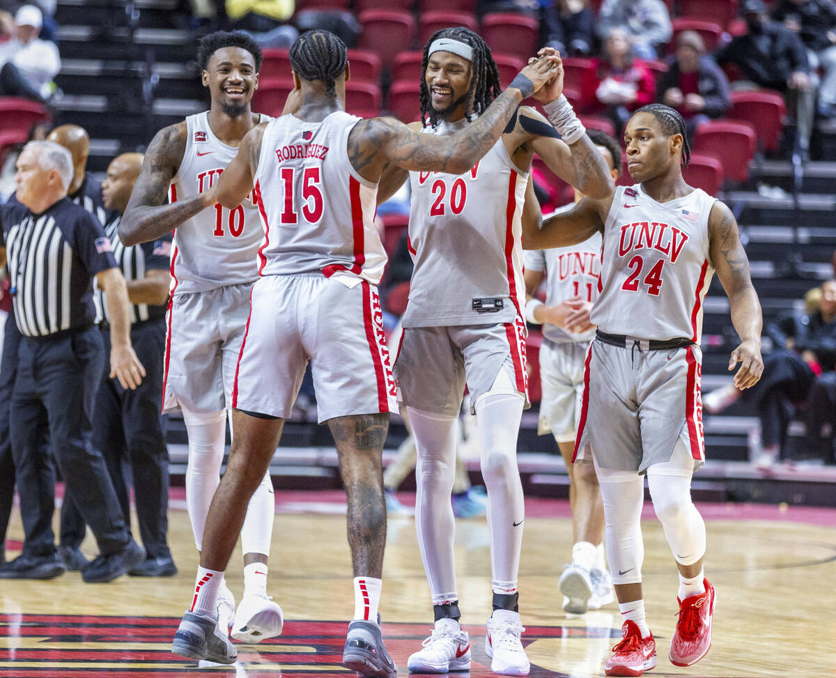 UNLV forward Keylan Boone (20) and teammates are congratulated on their lead by guard Luis Rodr ...