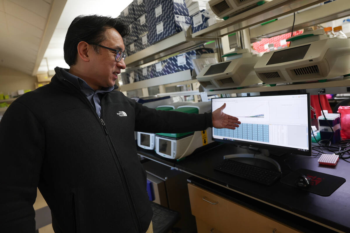 Dr. Edwin Oh gestures to a graph displaying data from his wastewater research at the UNLV Scien ...