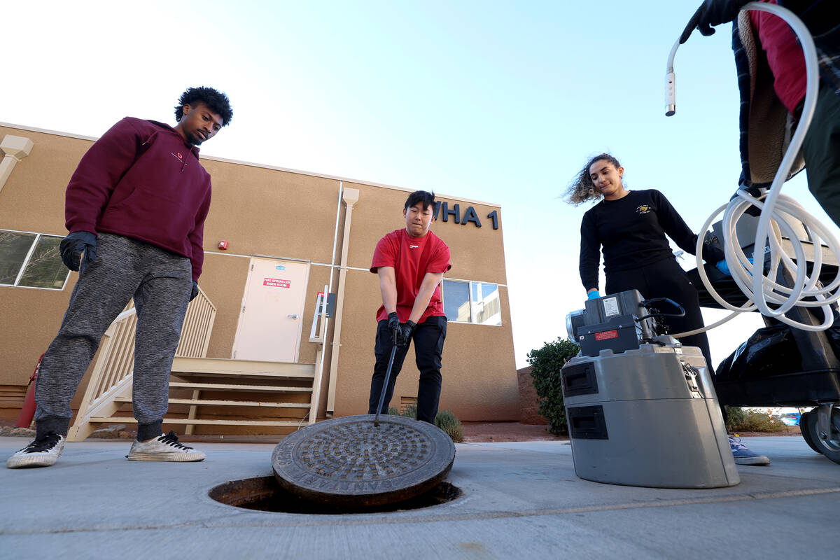 Students Tyler Houston, left, Chris Oh and Lexie Diaz demonstrate how they extract wastewater f ...