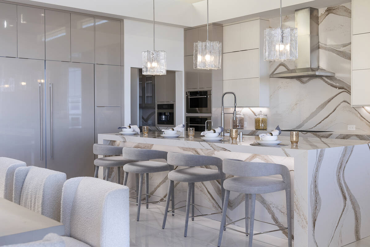 The kitchen features an island with seating. (Douglas Elliman of Nevada)