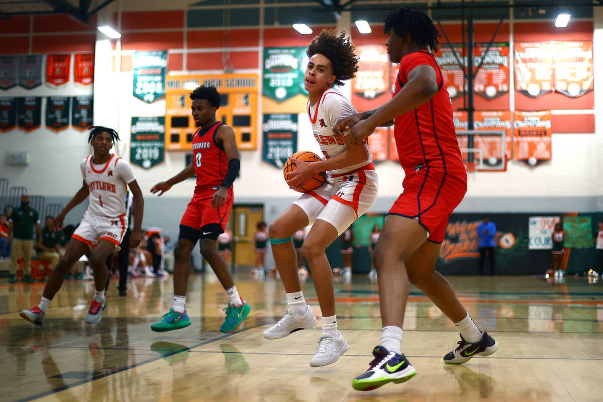 Mojave forward Devin Thomas (2) drives toward the hoop against Coronado center Tee Bartlett (13 ...