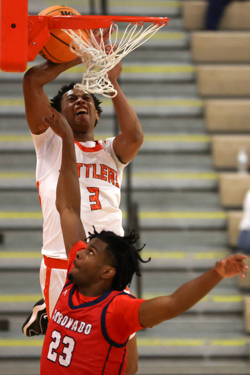 Mojave guard C.J. Shaw (3) tangles with the net while attempting to dunk against Coronado guard ...