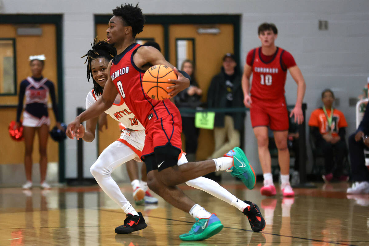 Coronado guard Jonny Collins (0) drives while Mojave guard Tony Williams (10) defends during th ...