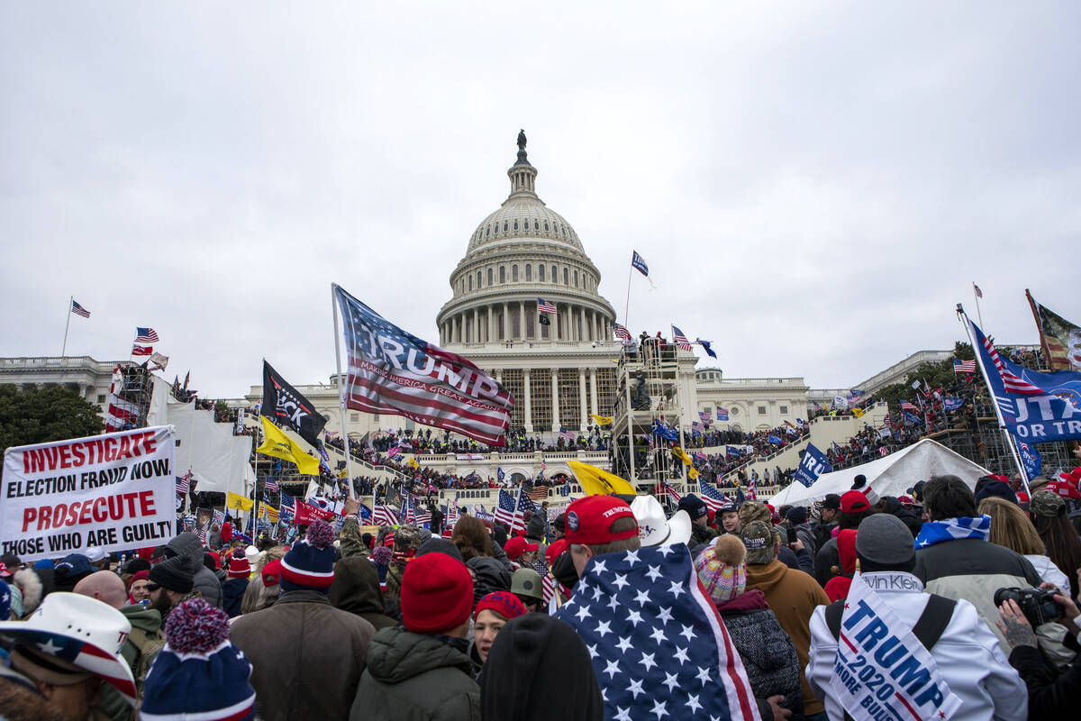Rioters loyal to President Donald Trump gather on the West Front of the U.S. Capitol in Washing ...