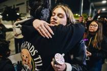 Leighonna Post, facing, hugs a mourner during a vigil for her mother, Rebecca Post, and brother ...