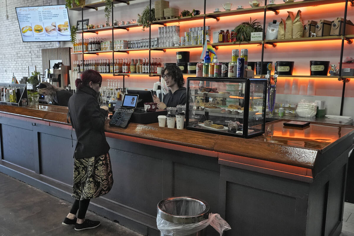 A customer buys a cup of coffee at the Blind Tiger Cafe Wednesday, Jan. 10, 2024, in Tampa, Fla ...