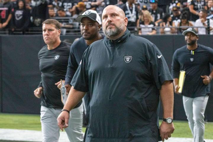 Raiders offensive line coach Carmen Bricillo takes the field before an NFL game between the Rai ...