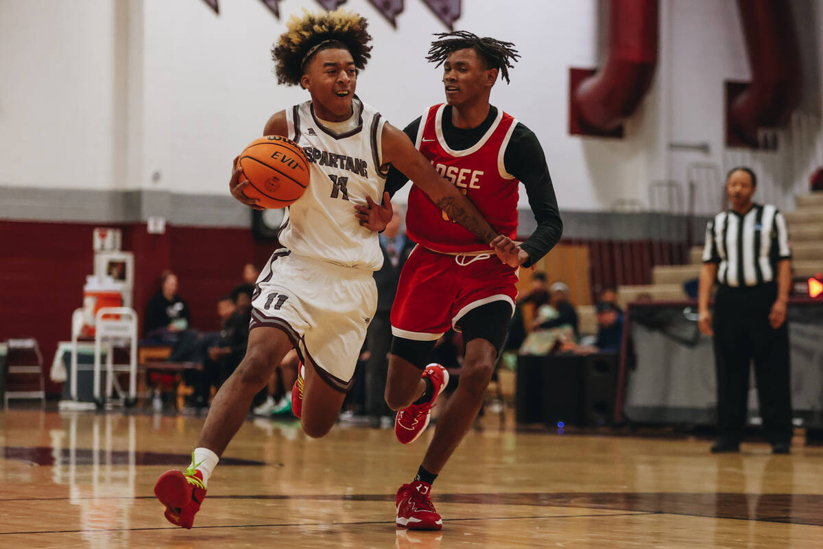 Cimarron-Memorial small forward Geremiah Rone (11) fights to move the bal down the court during ...