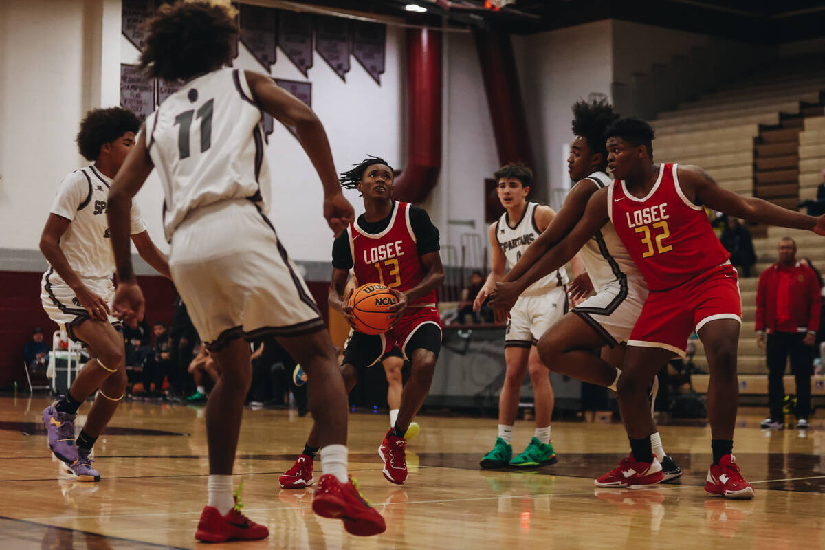 Somerset-Losee guard KeSean White (13) moves the ball down the court during a game at Cimarron- ...