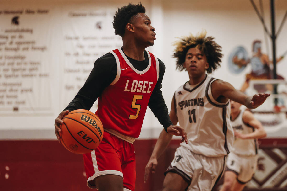 Somerset-Losee guard Antwan Jones (5) dribbles the ball during a game at Cimarron-Memorial High ...