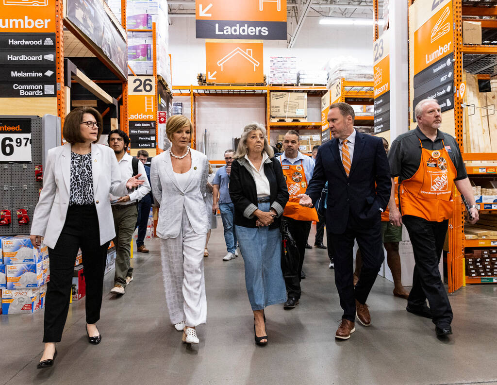 Scott Glenn, vice president of asset protection at the Home Depot, second right, leads a tour o ...