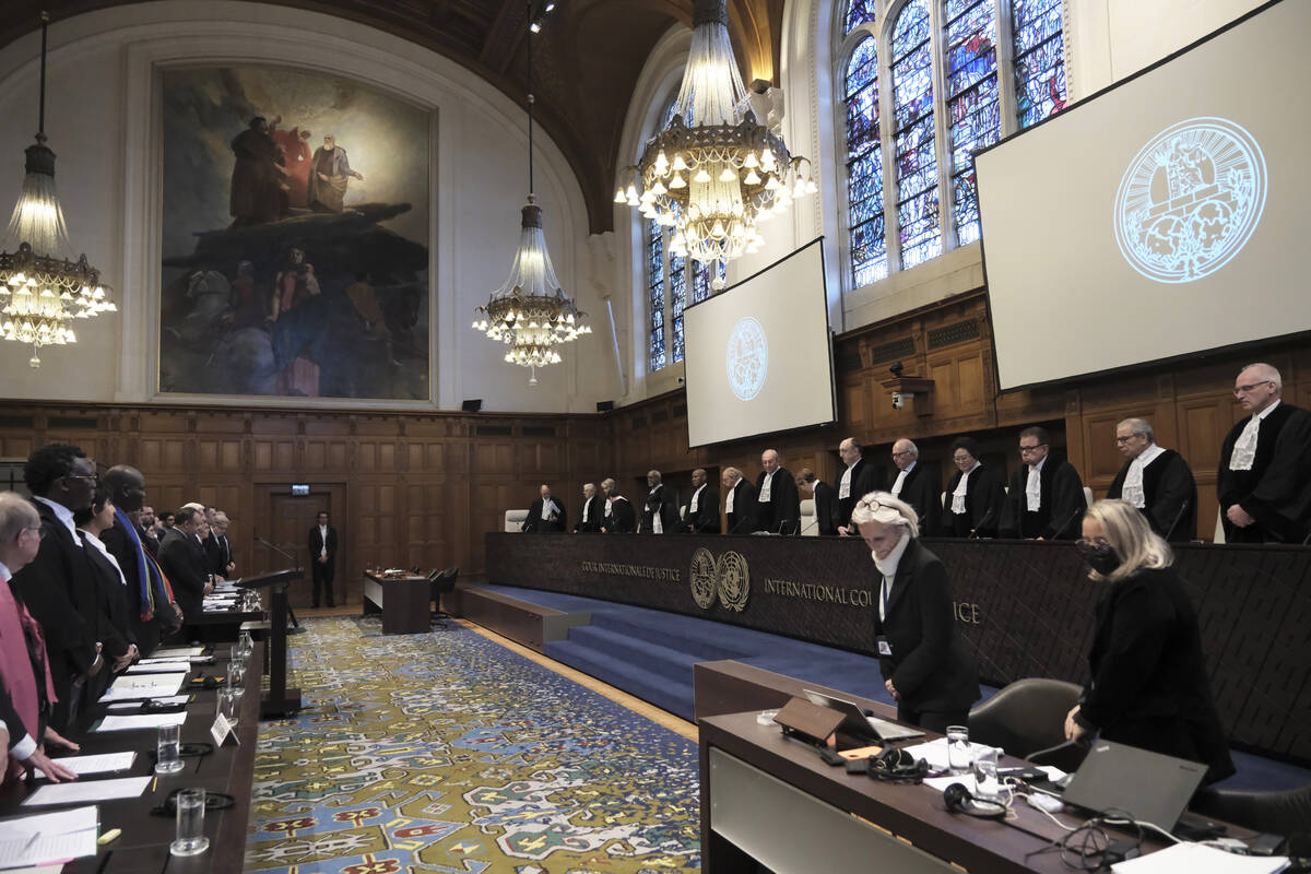 Judges and parties stand at the opening of the hearings at the International Court of Justice i ...